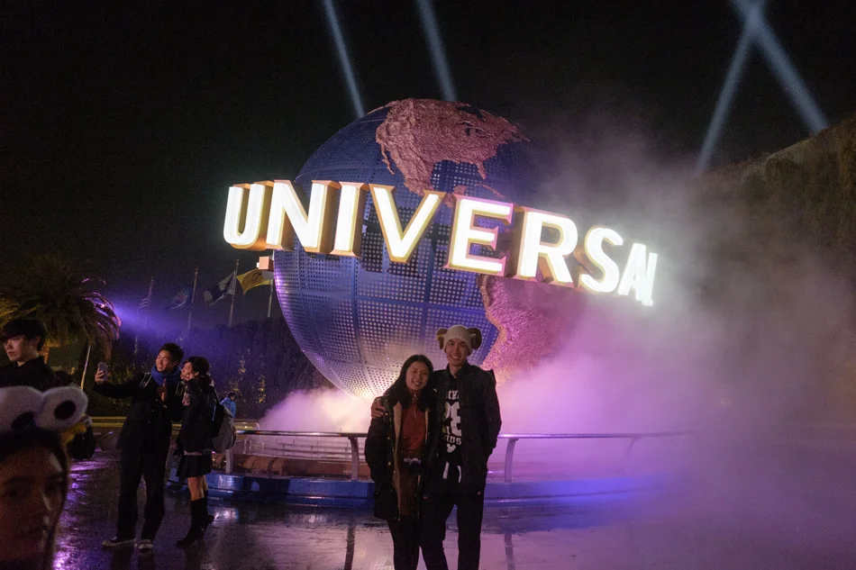 70 cute couple pose in front of Universal Studios globe.jpg