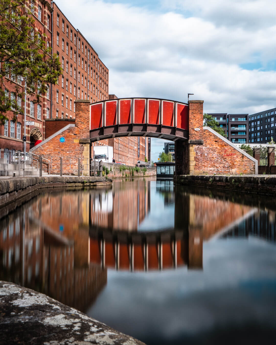 Old Red bridge reflected in a canal in Ancoats Manchester.jpg