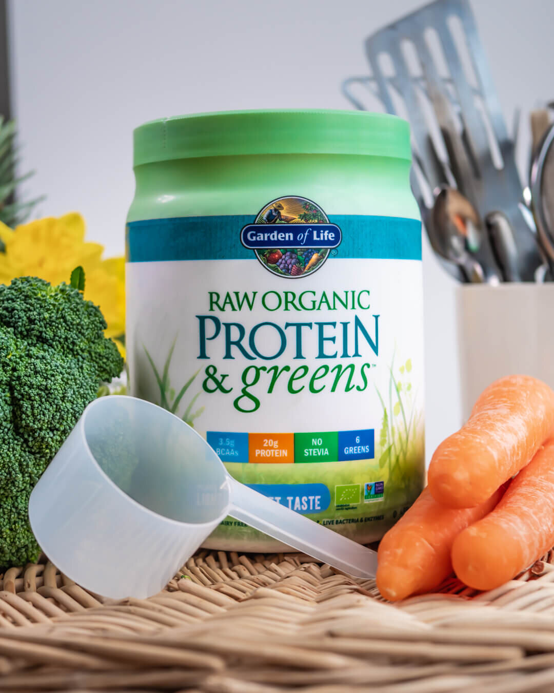 Garden of Life RAW organic protein captured next to three carrots, a piece of broccoli and a scoop-1 (1).jpg