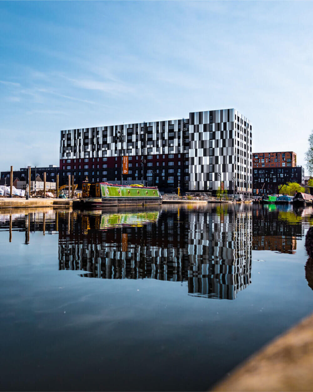 Perfect reflection of a modern building in New Islington Marina, Manchester