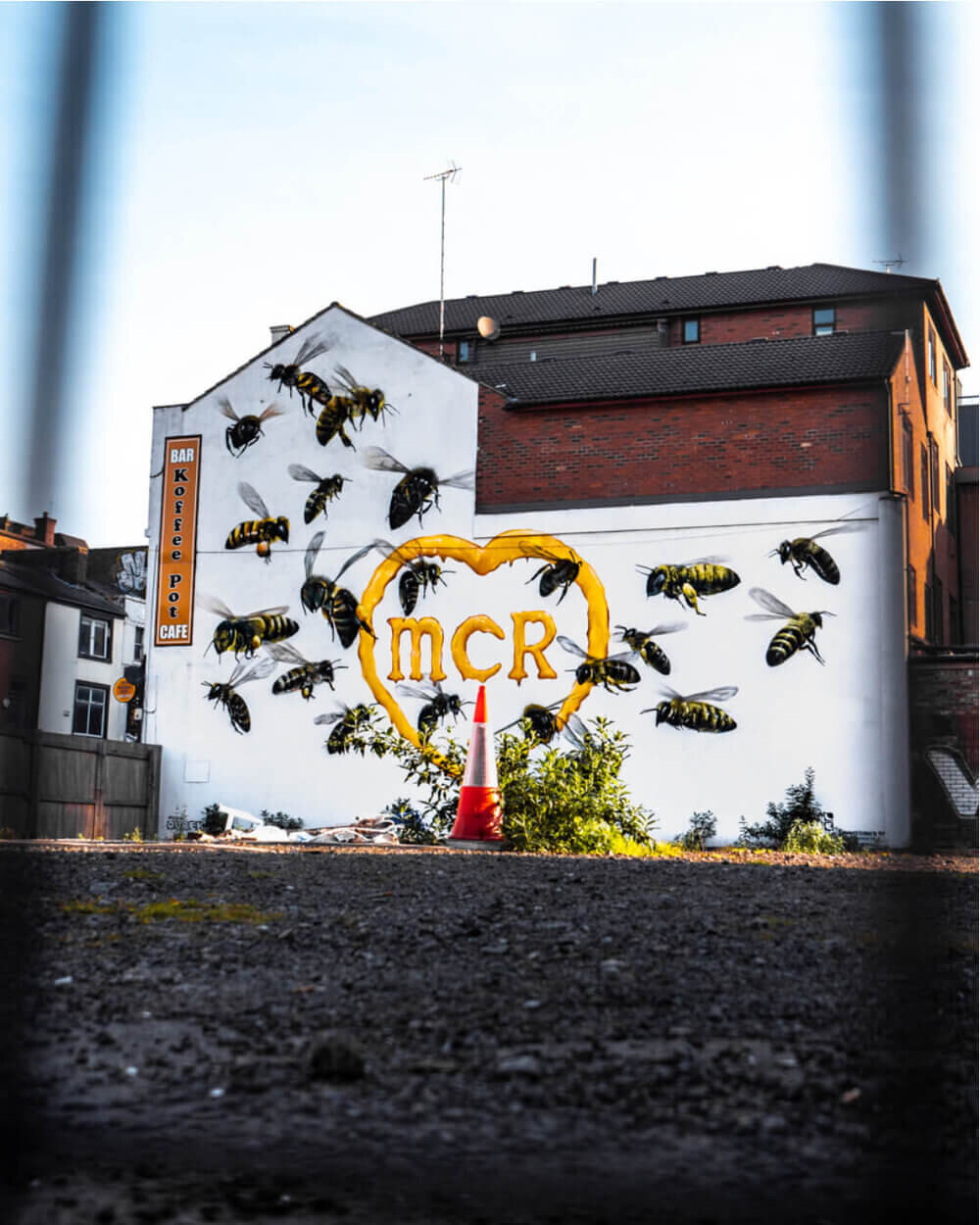 MCR graffiti showing 23 bees on the side of a building in Northern Quarter, Manchester
