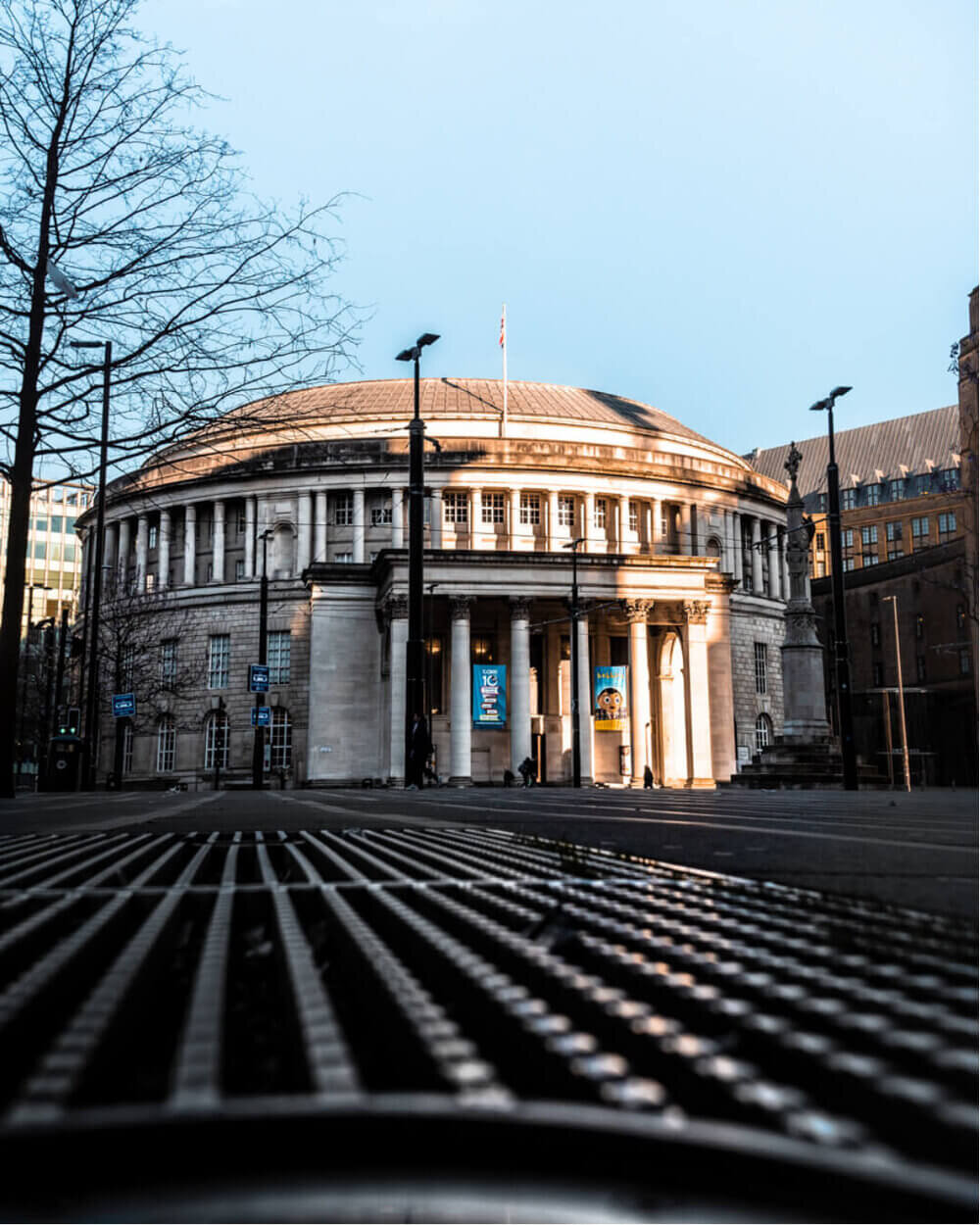Architecture photography by Chris Curry showing the Manchester Central Library with the sun shining on it in the early hours of the morning