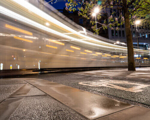 Long exposure photography of a Metrolink tram at night by Chris Curry