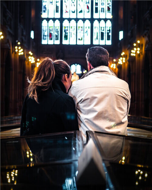 A woman and a man inside of John Rylands Library