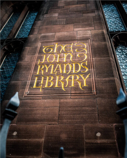 Wall mural outside of John Rylands Library which states the name