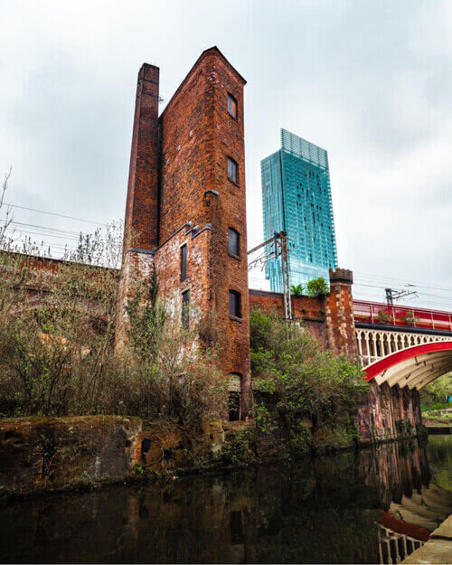 Old red brick building next to Beetham tower in Castlefield, Manchester