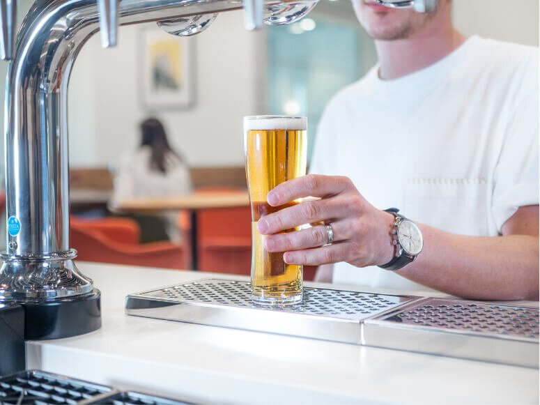 Close-up photography showing man holding a pint of beer