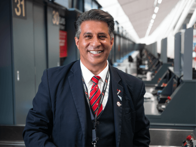 Portrait photography of a smart looking Airport worker wearing a full suit