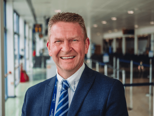 Corporate portrait photography showing an airport manager smiling 