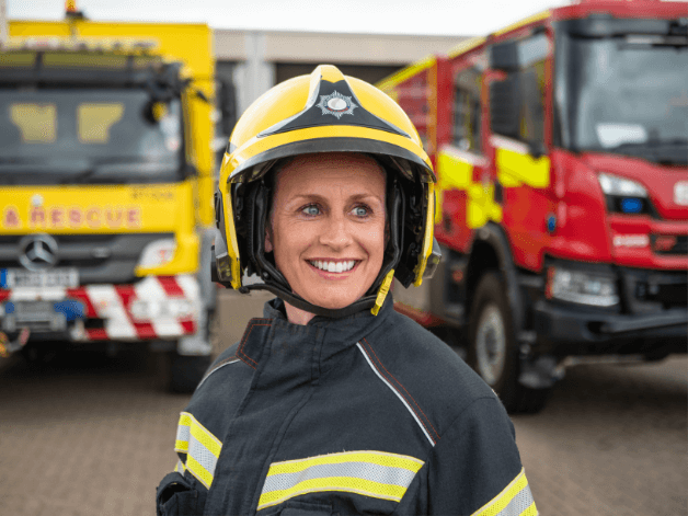 Hero staff portrait photography showing a female firefighter at Stansted airport wearing her full uniform. 