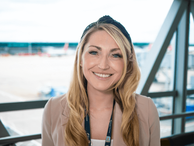 Smiling staff headshot capturing a young blond woman and Stansted Airport