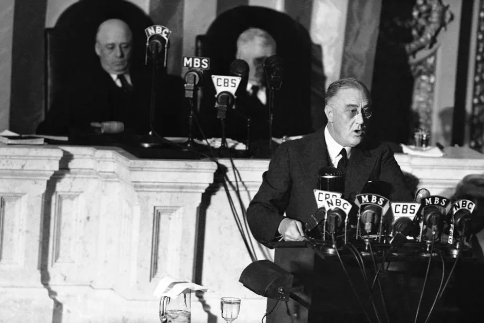 President Franklin D. Roosevelt addresses a joint session of Congress on January 6, 1941. Speaker Sam Rayburn, left, and Vice President John N. Garner are listening behind him.