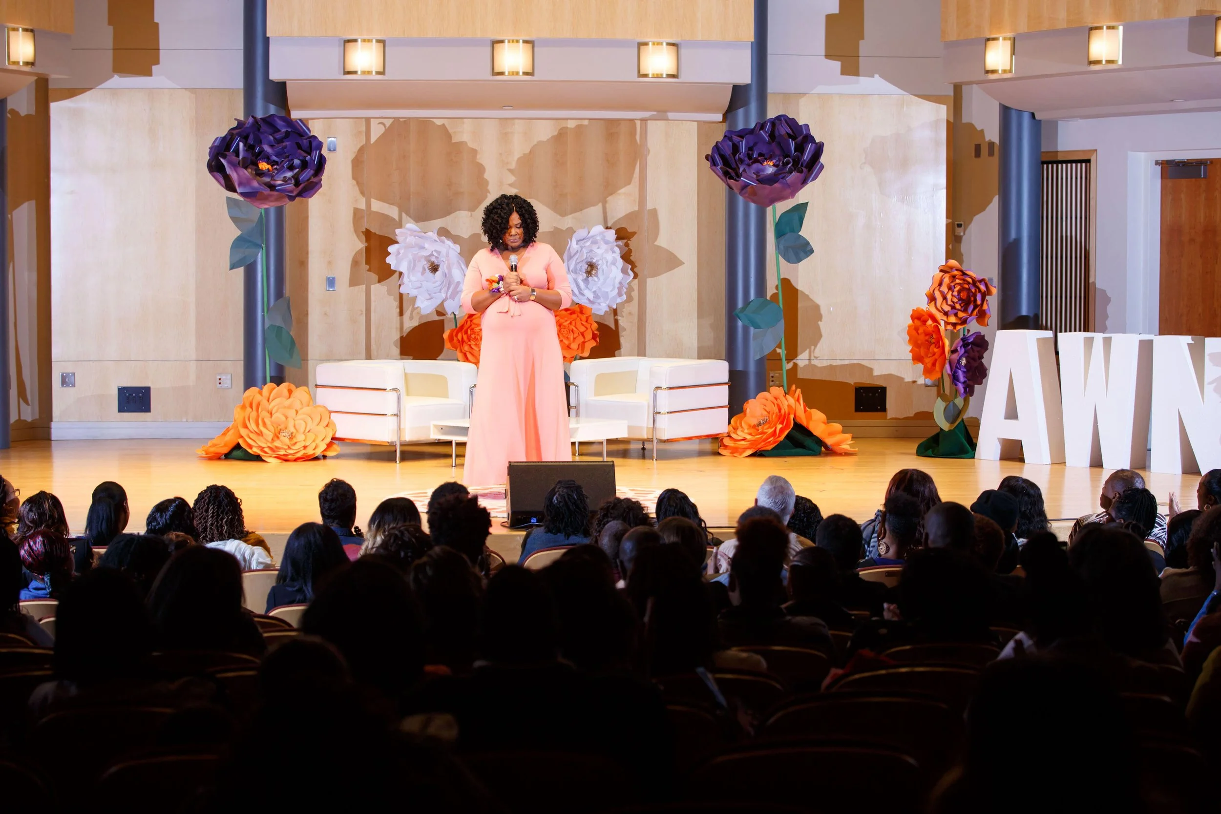 Stacy Crawley transformational speaker addressing a full audience at a women's conference on faith identity and purpose