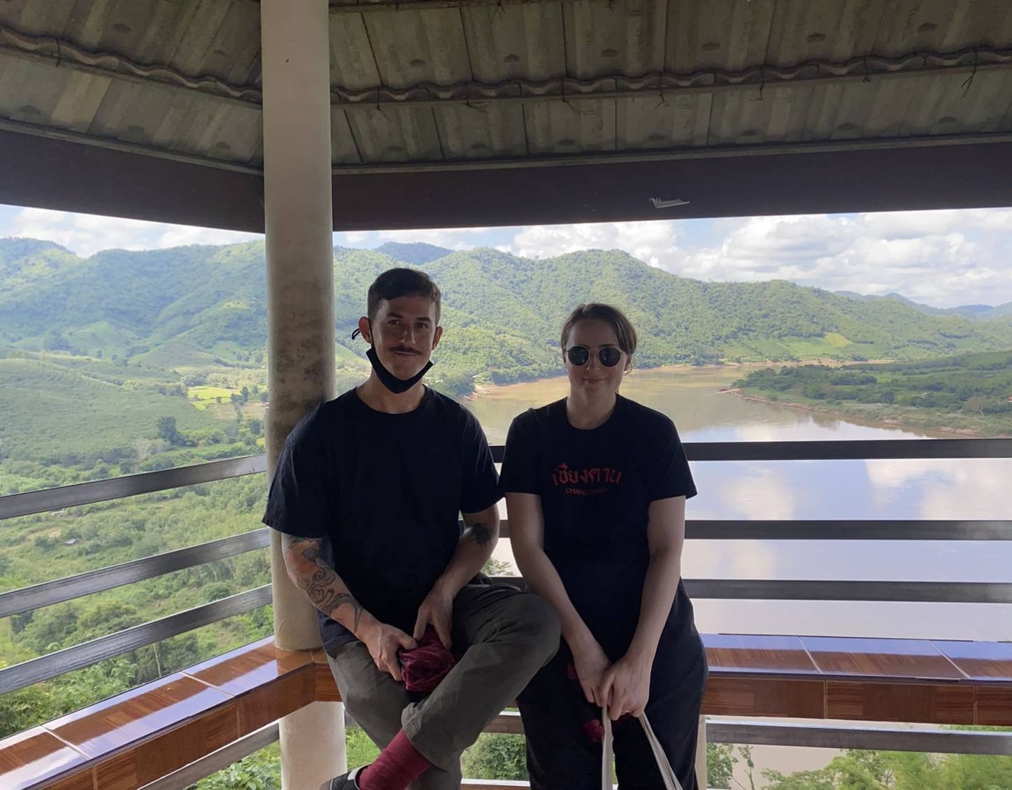 James and Amy sitting in a pagoda with a beautiful view.jpg