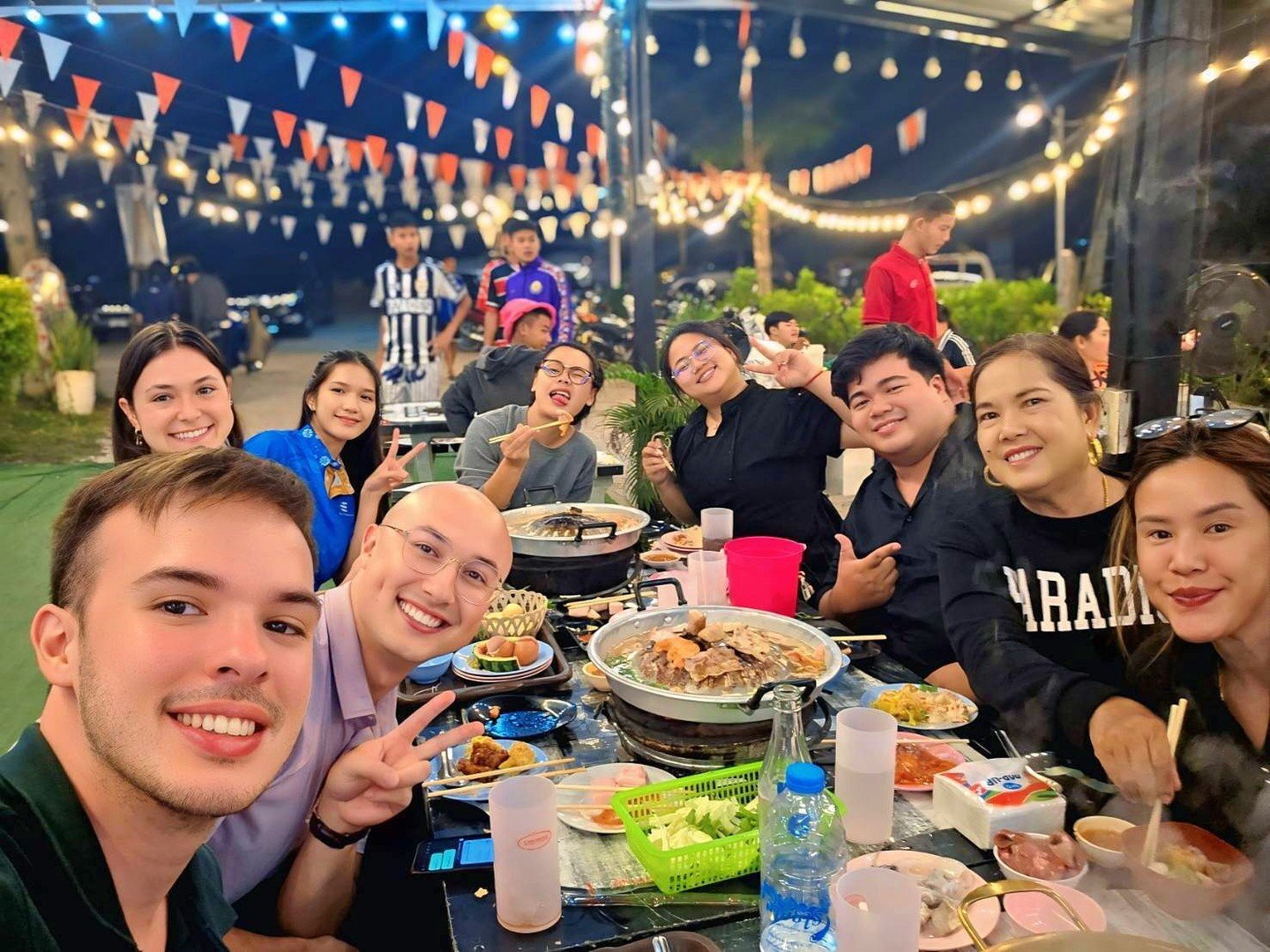 Thai BBQ night just became the coziest goodbye! 

Teacher Nick and Teacher Javier sat right in the middle of the long table, KET family all around, smoke rising, meat sizzling, somtam bowls passing hand-to-hand, and laughter louder than the grill. 

