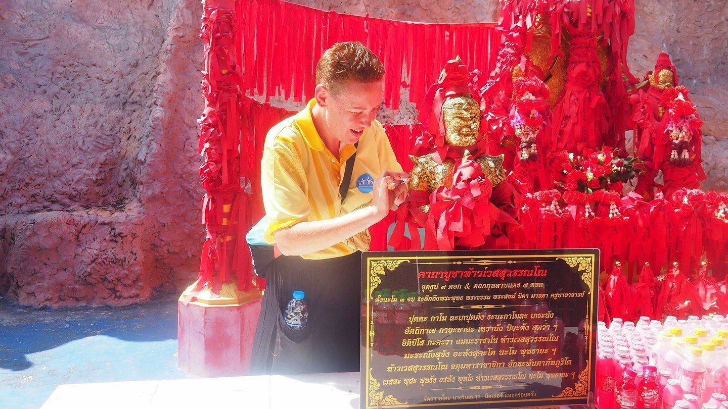 Temple moment that stopped time! 

Teacher Sam stood quietly in the heart of Sukhothai, surrounded by red ribbons and golden statues, carefully sticking gold flakes to Buddha statue and bowing her head in respect.  Every gentle movement, every soft &