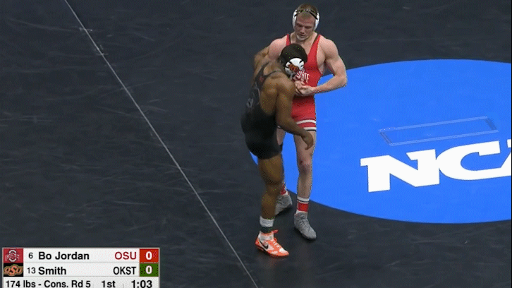 Bo Jordan again finishes a back trip off the outside Armpit Lock but this time uses a left arm club to assist.