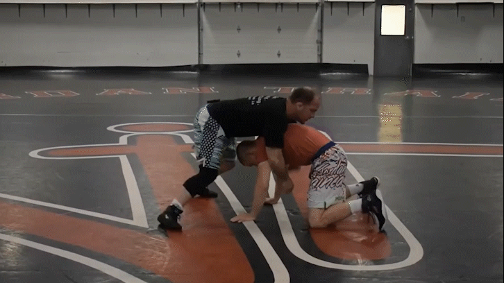 Micah Jordan and Graham Head Coach Travis McIntosh demonstrating an Auble drill.