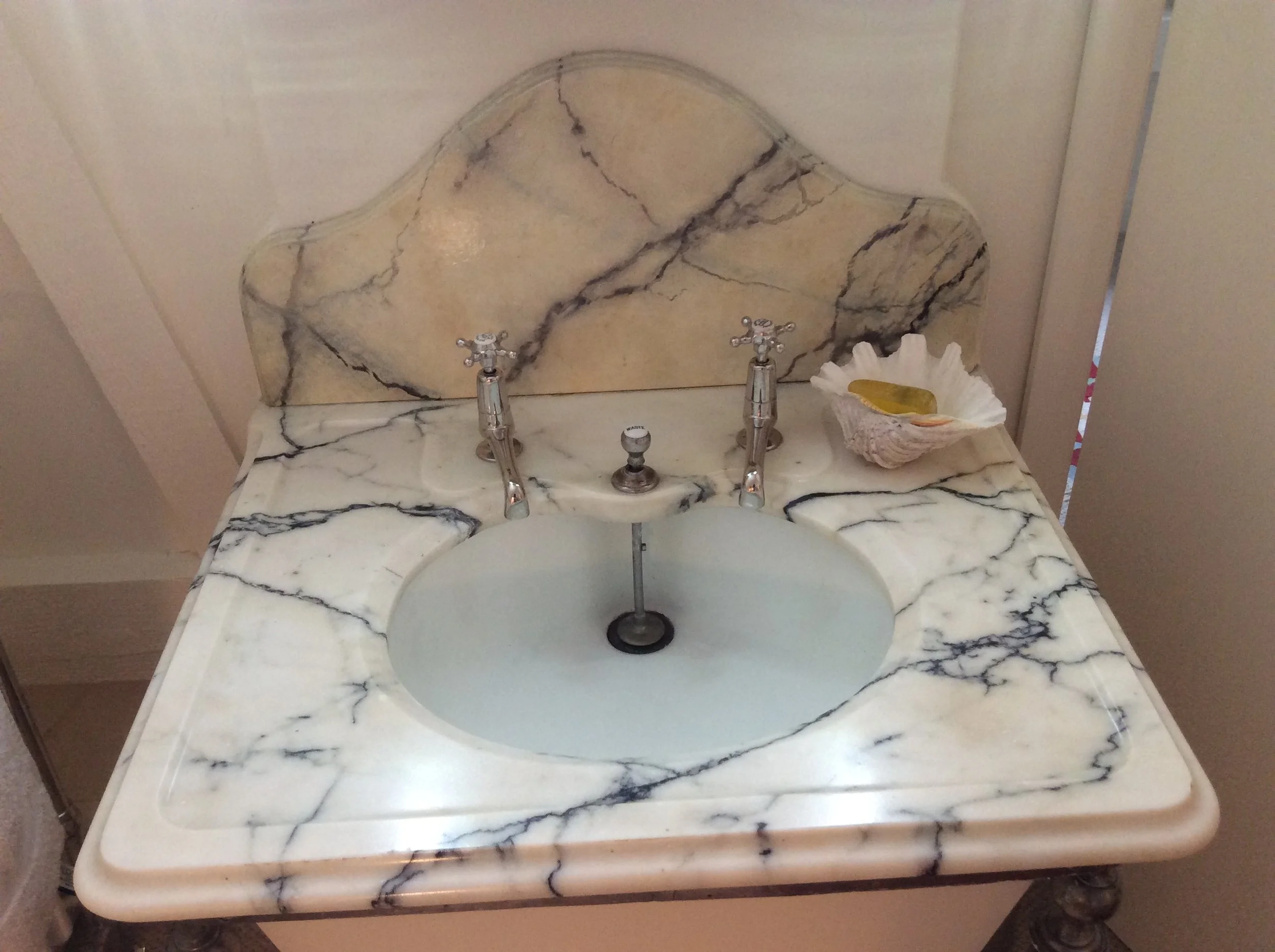  Wash-hand basin, with wooden splash-back, painted in “faux” carrara marble to match real marble top. 