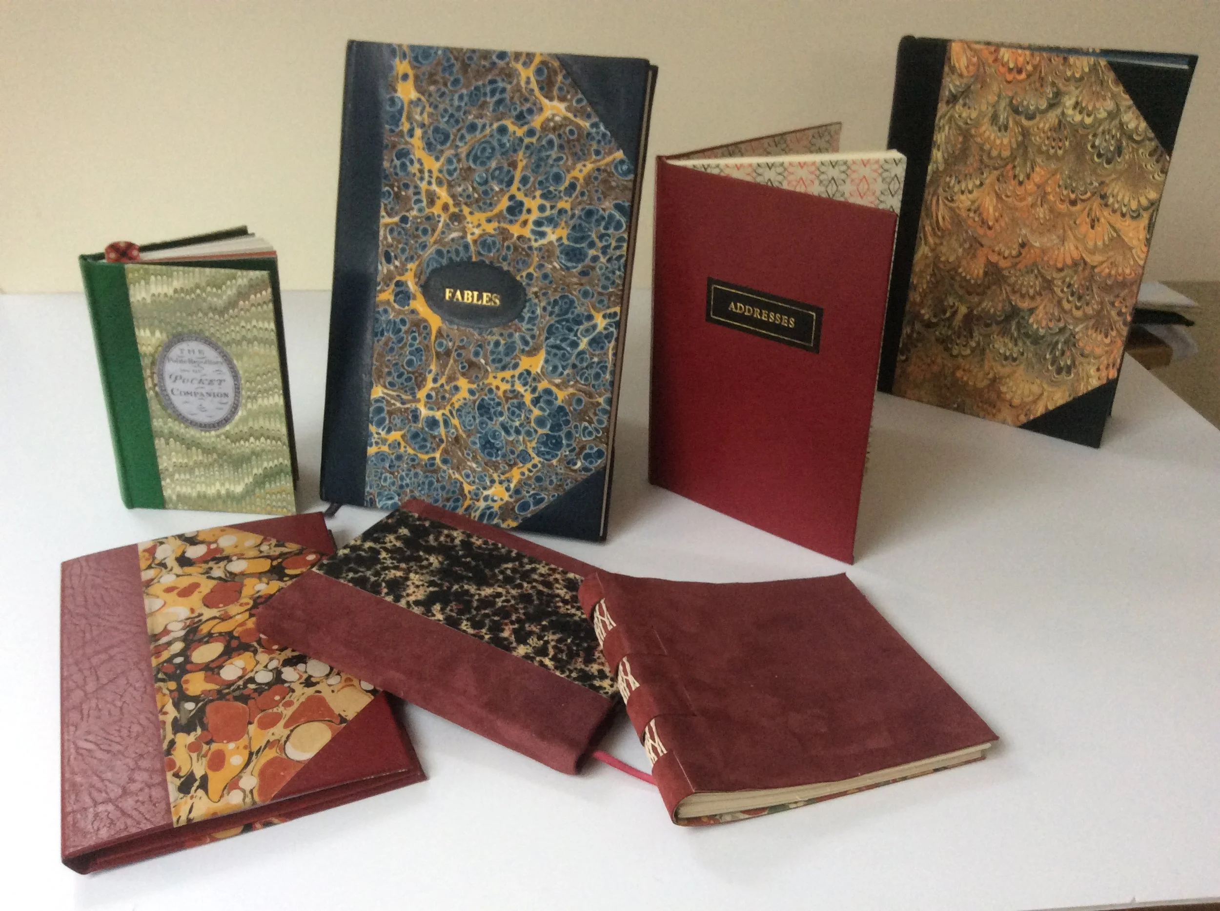  Address books, notebooks and paper-backs re-bound into hard covers. 
