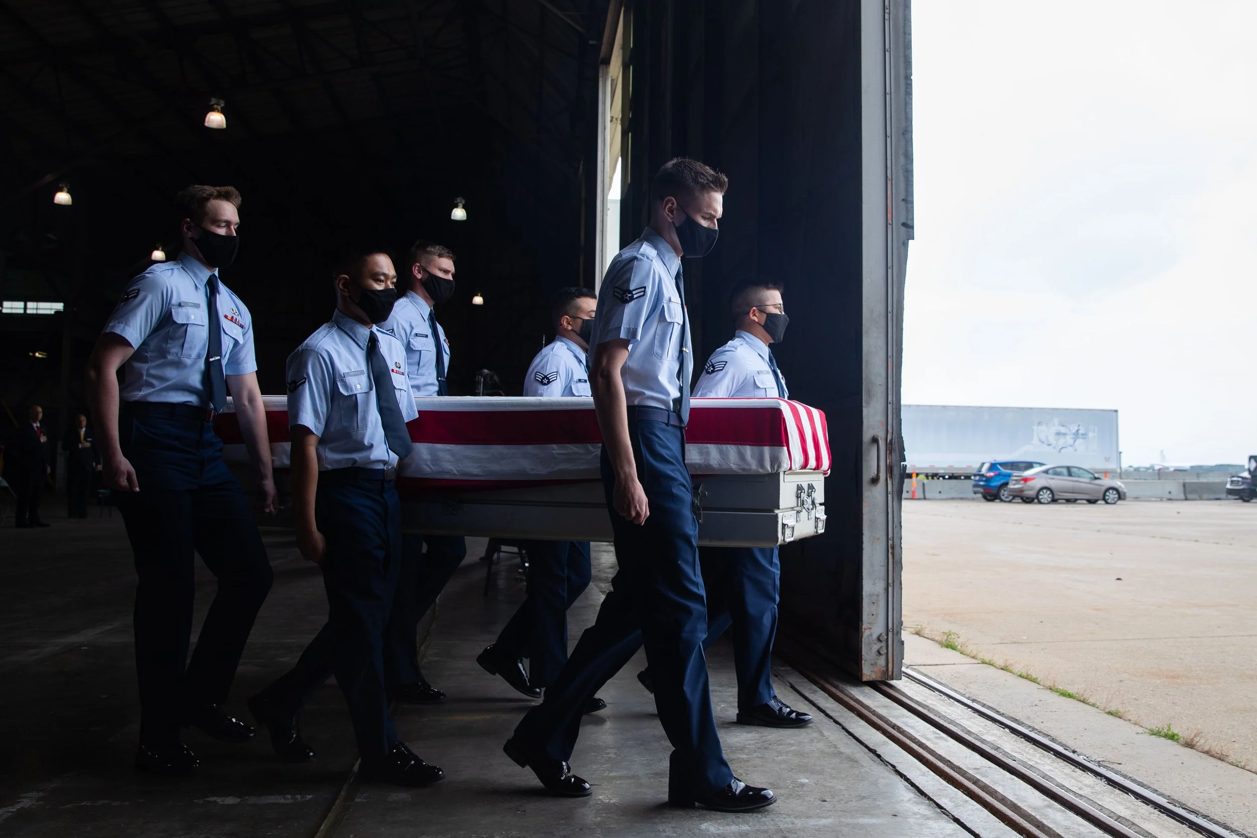  U.S. Air Force members carry a casket containing the identified remains of soliders who died at Pearl Harbor during an Honorable Carry ceremony at the Lincoln Airport in Lincoln on Thursday, June 24, 2021. (Lily Smith/Omaha World-Herald) 