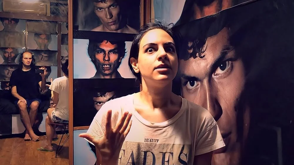 A woman sits in stark lighting, surrounded by images of Richard Ramirez.
