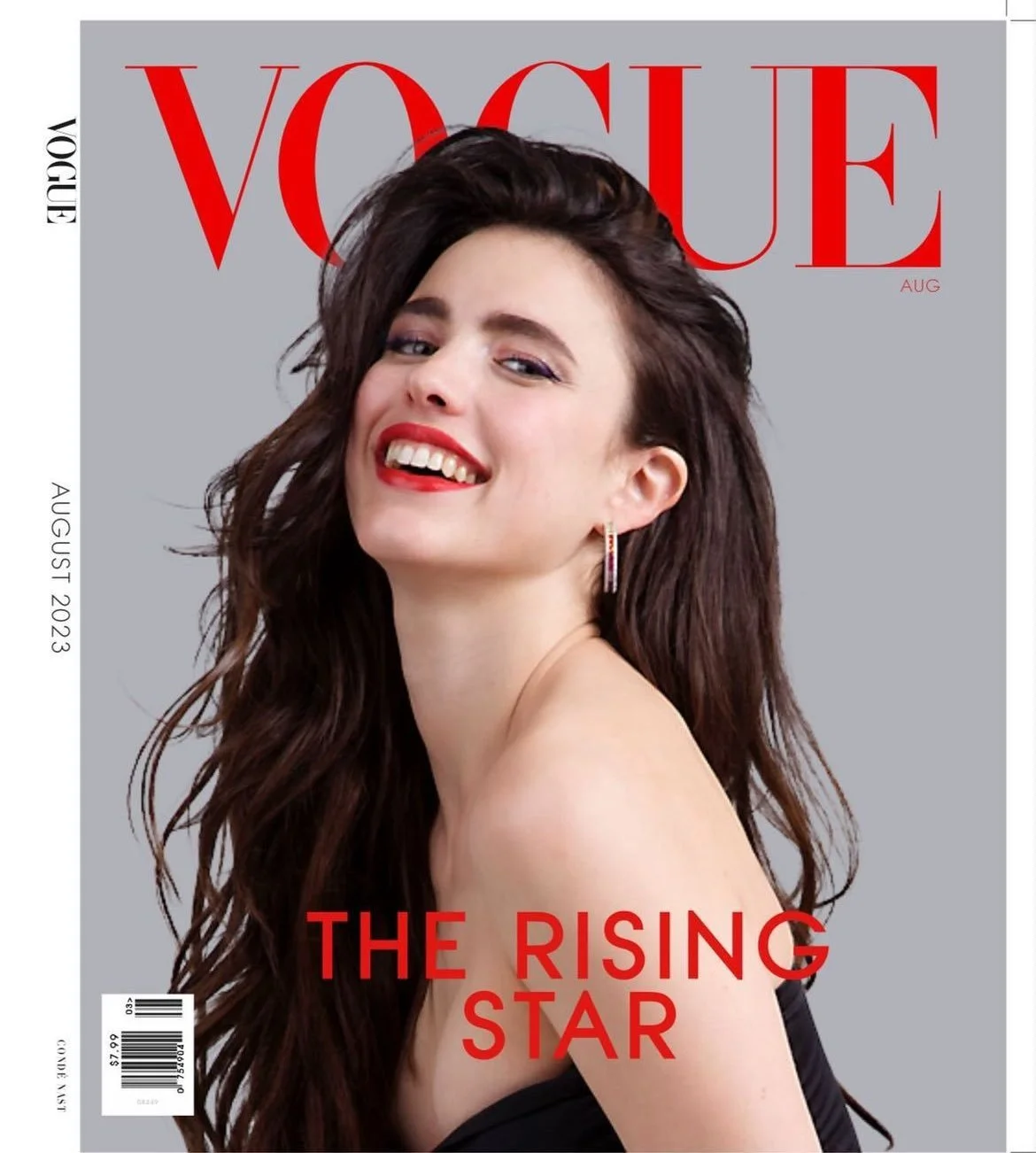 A young woman is laughing on the cover of Vogue magazine.