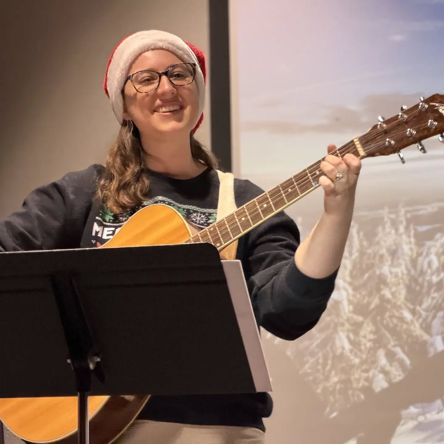 Last month Rhythmic Roots Music Services, LLC had its fourth holiday recital at the Koelbel Library! I am so proud of all of my students and their hard work last year. Excited for 2026!

[Image description 1: Bonnie leading an opening song.]
[Image d