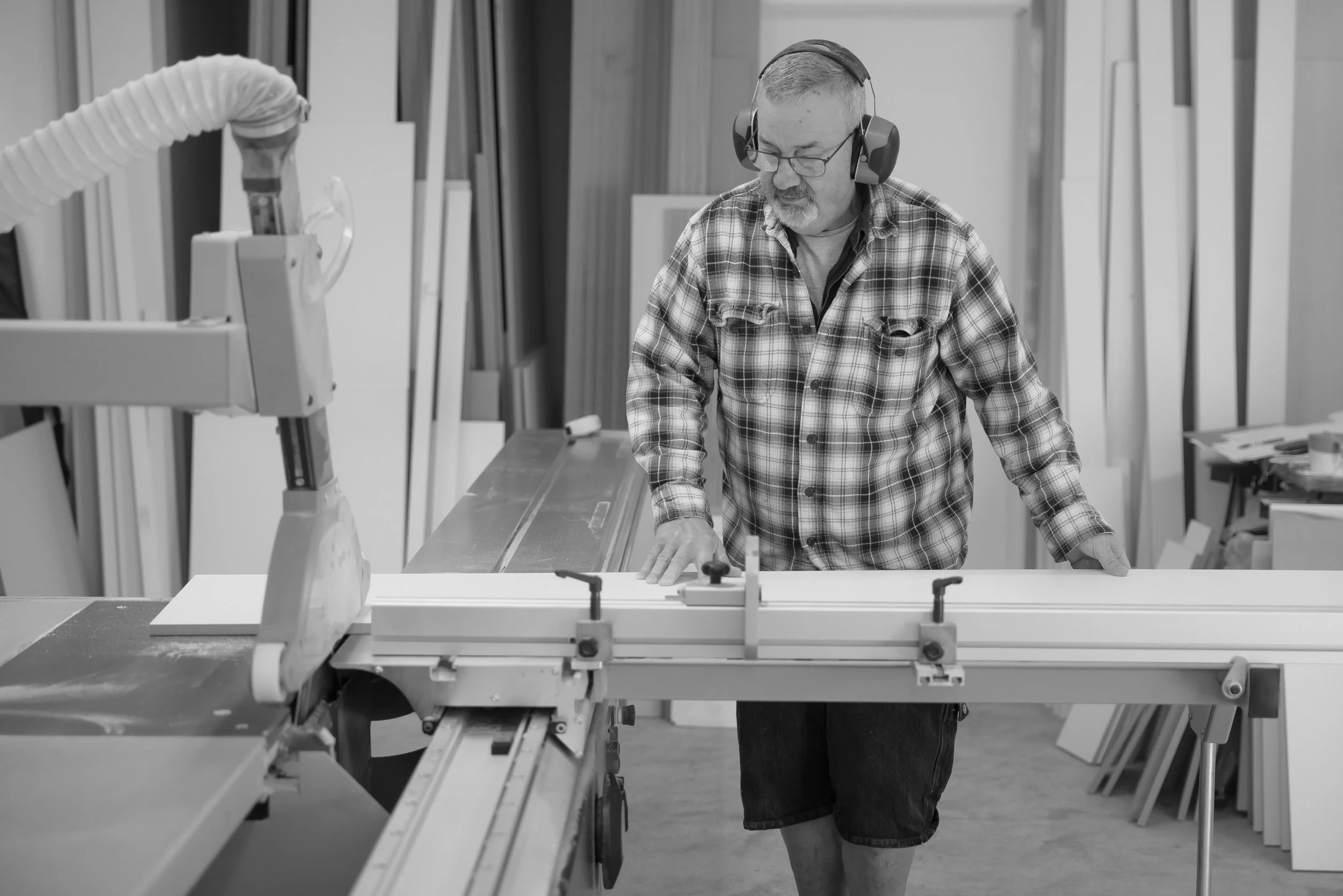 Keith Hollow, Redwood Kitchens - Wellington Kitchen Maker and designer cutting timber panels for a custom designed kitchen in his showroom, Tawa, Wellington
