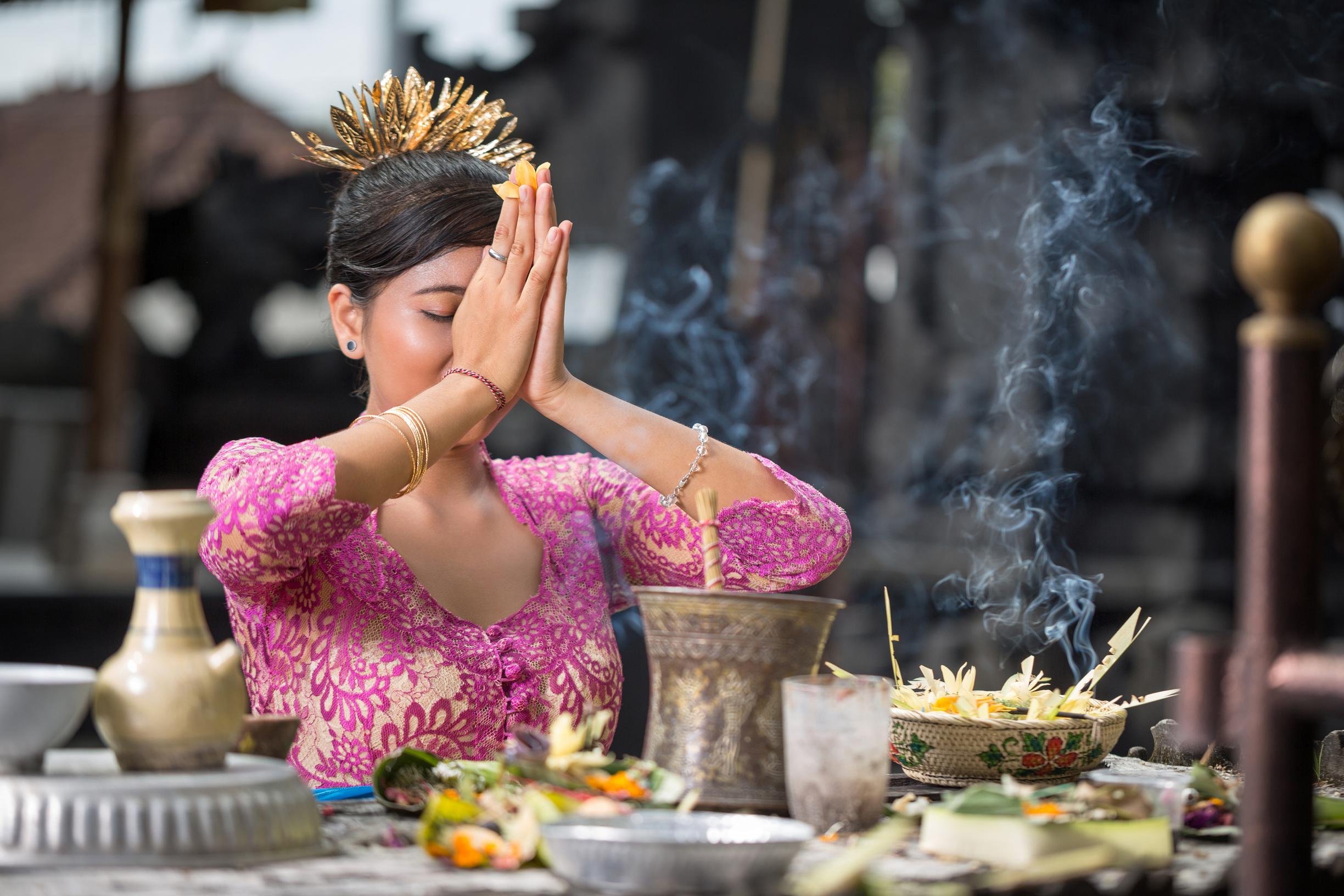 Woman prays in a temple in Bali, Indonesia.