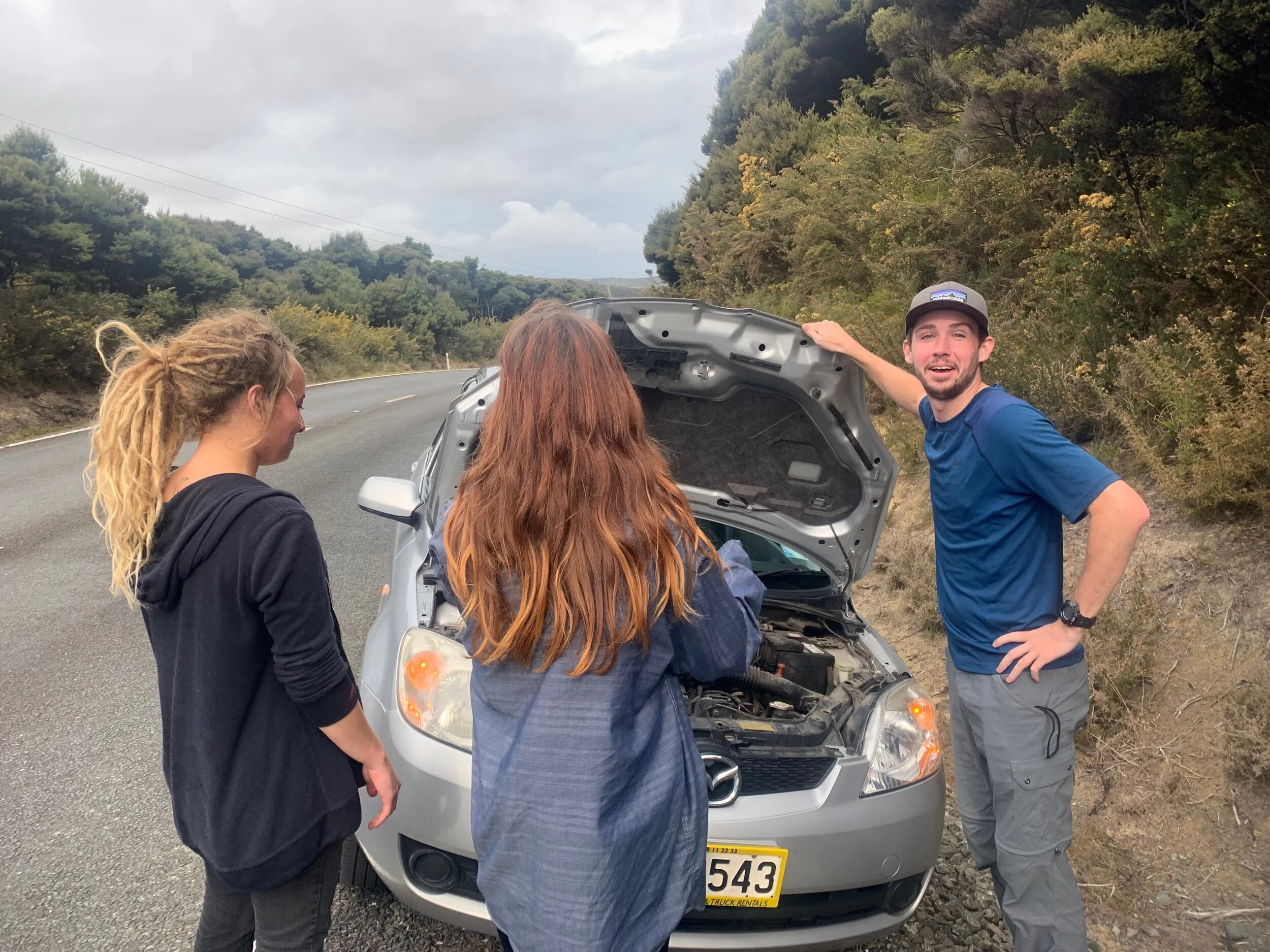 Ethan pretending to know car things.