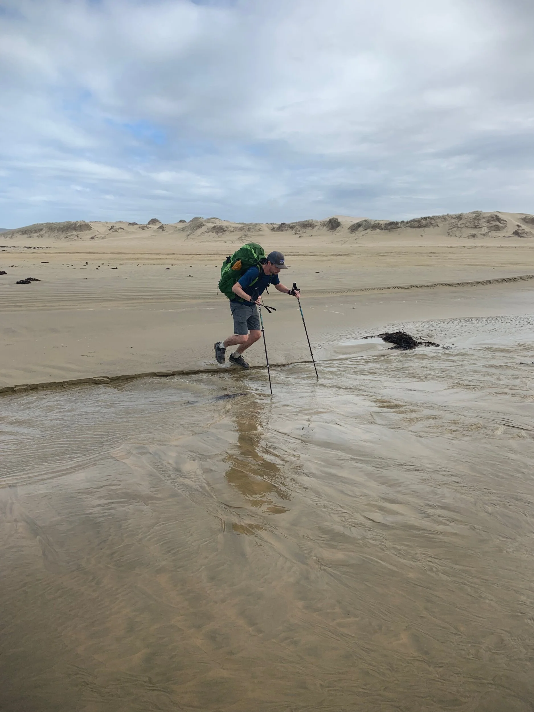 Ethan crossing the Te Paki stream. His feet get wet here despite his best effort.