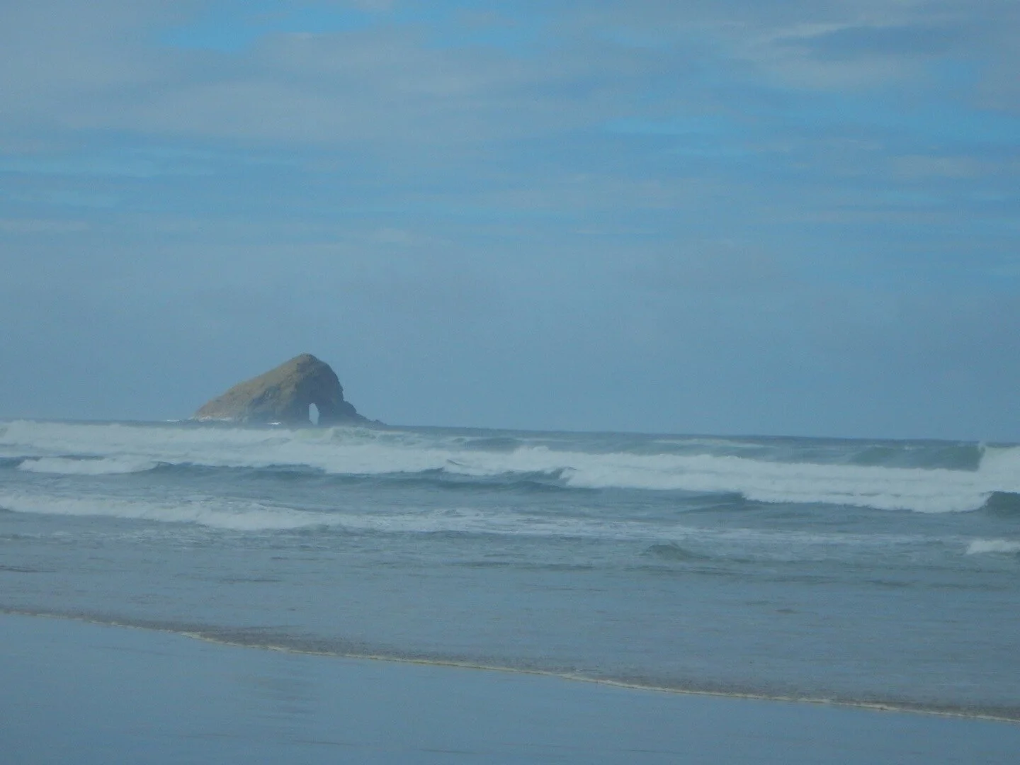 Sea arch in the middle of the ocean.