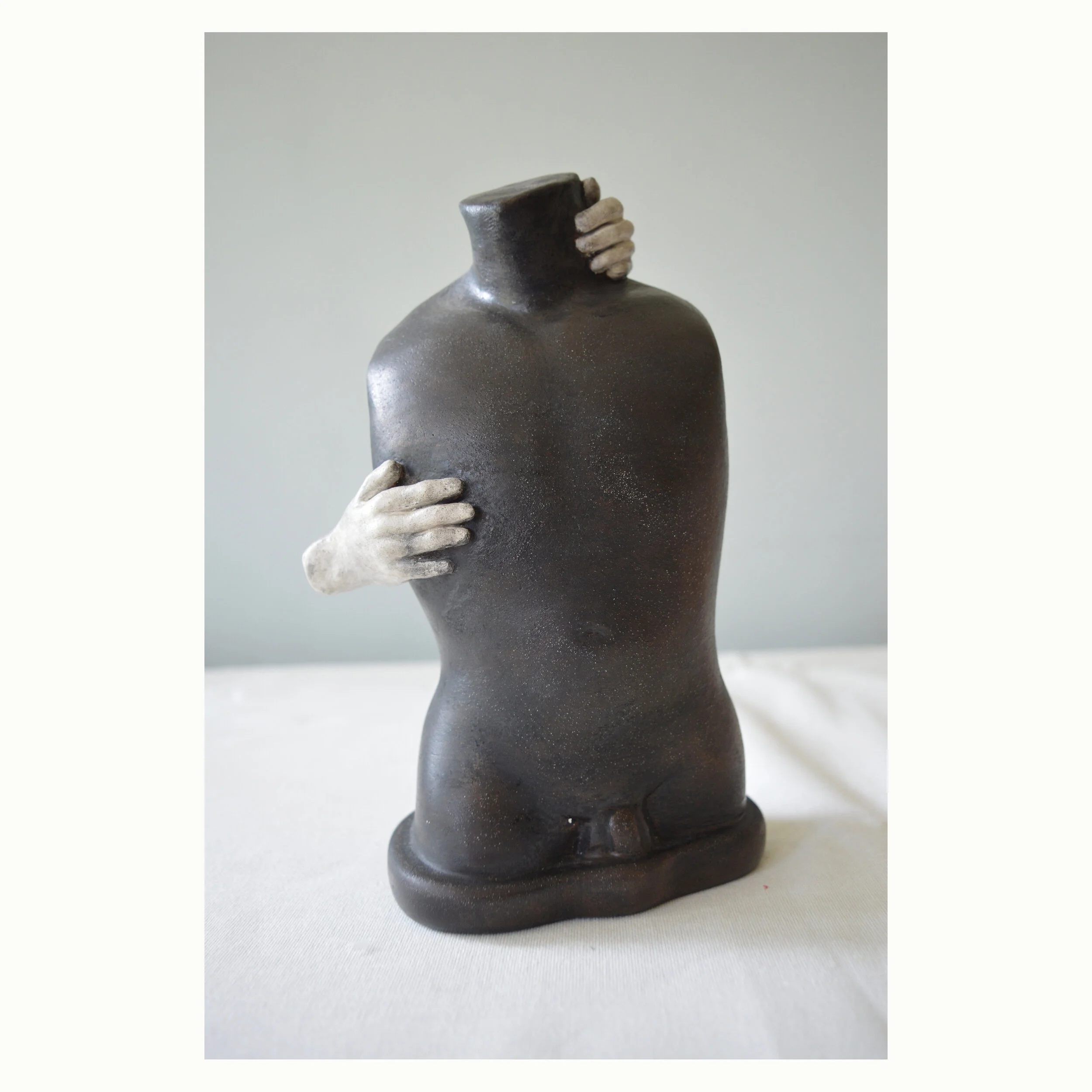 Black figure with two hands