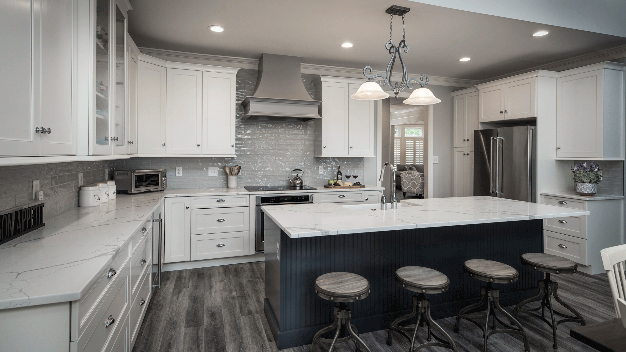 sleek kitchen remodel with flooring, cabinets, pendant lighting, recessed lighting, tile backsplash, island, seating