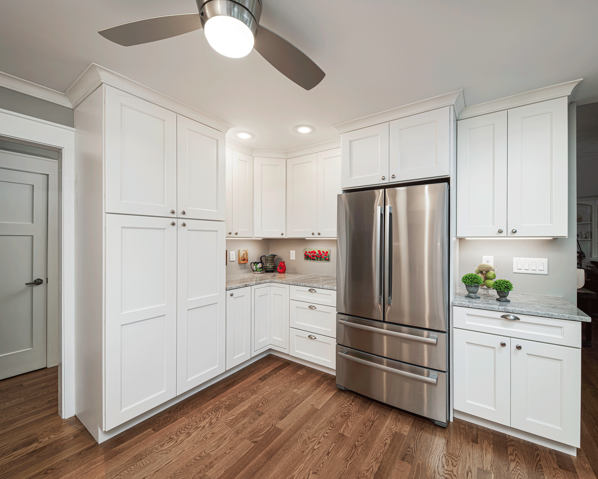 kitchen remodel with lighting, island, cabinets, seating, and decor