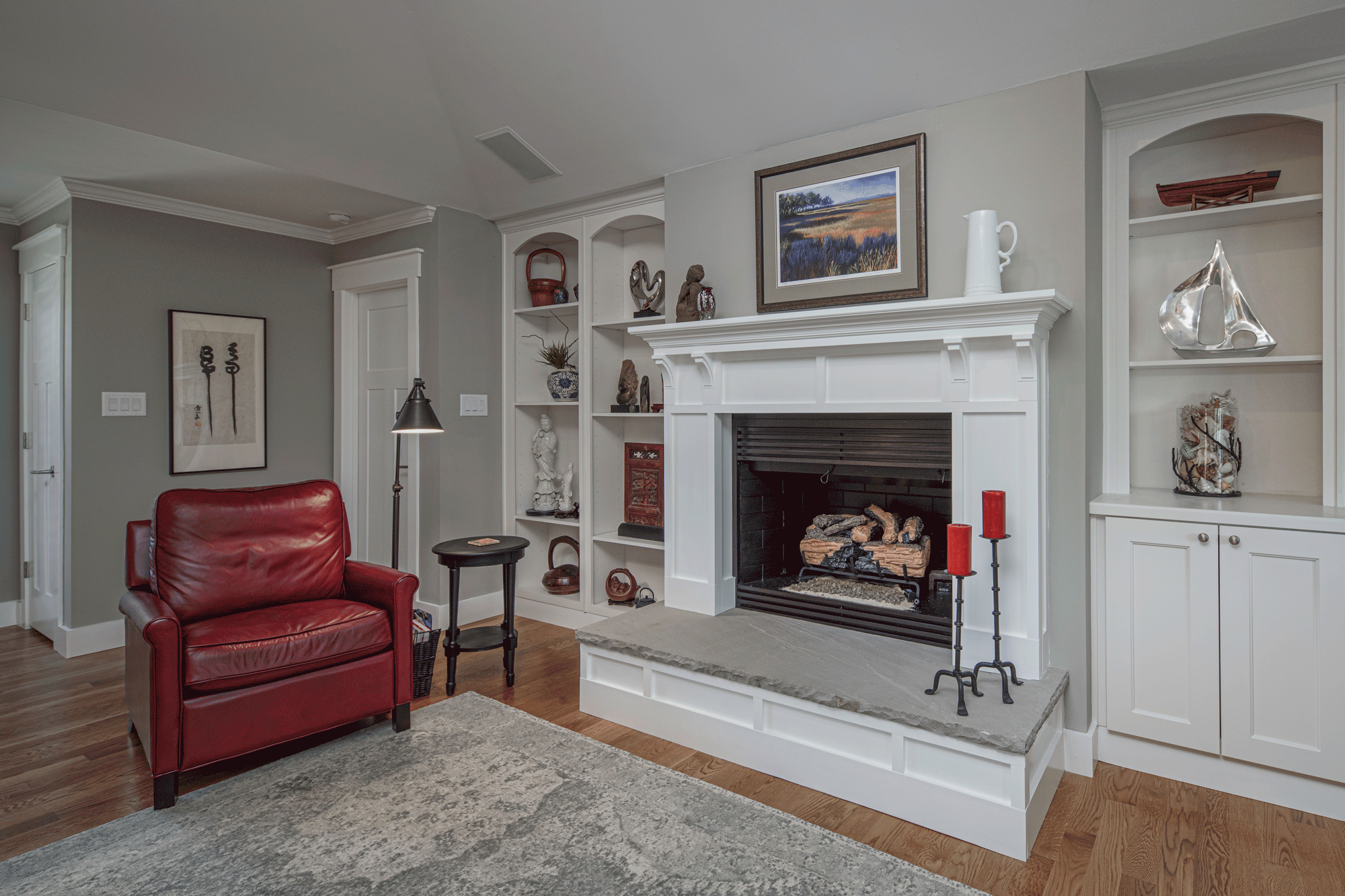 living room design with fireplace, built in shelves, seating, decor