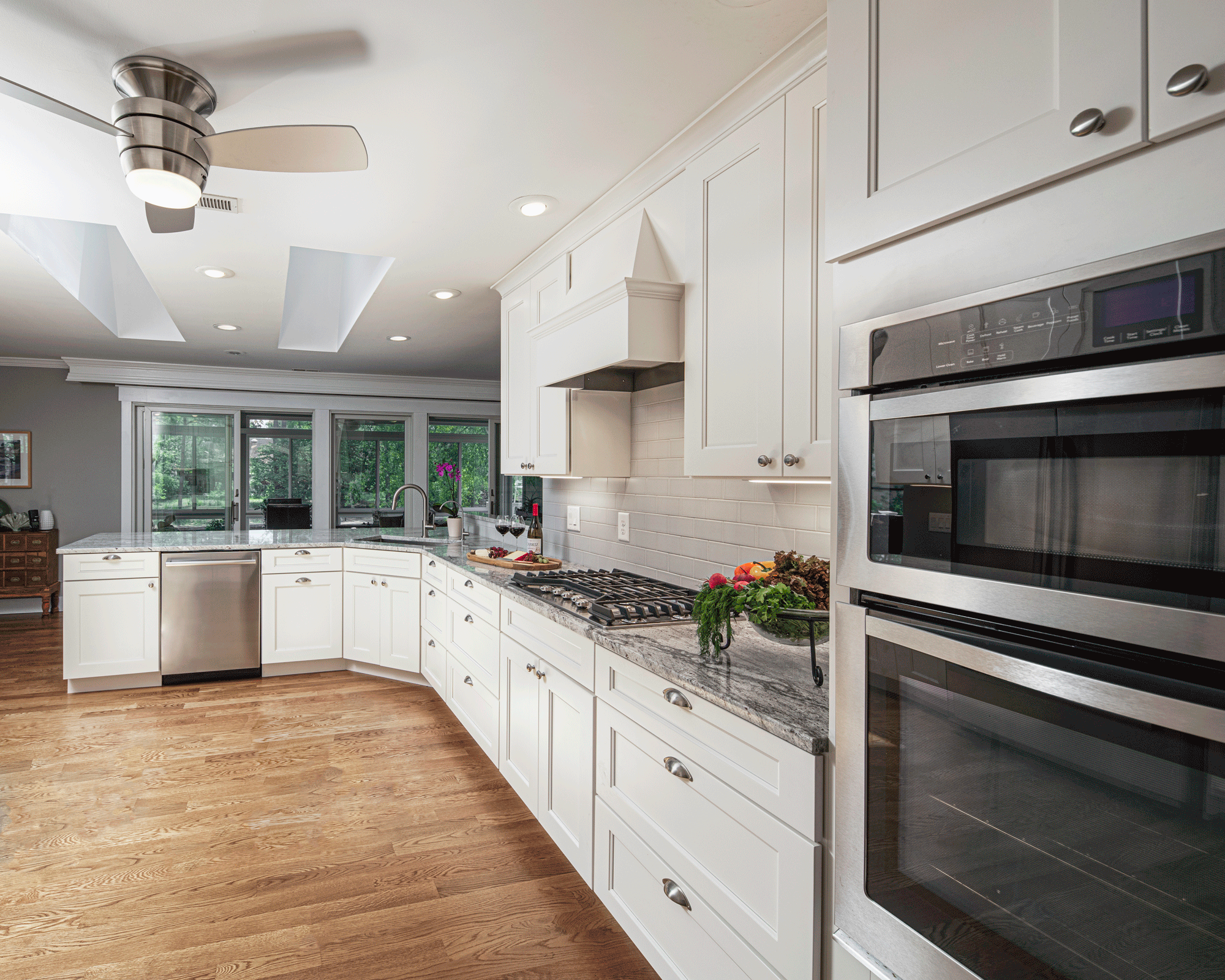 kitchen remodel with lighting, island, cabinets, seating, and decor