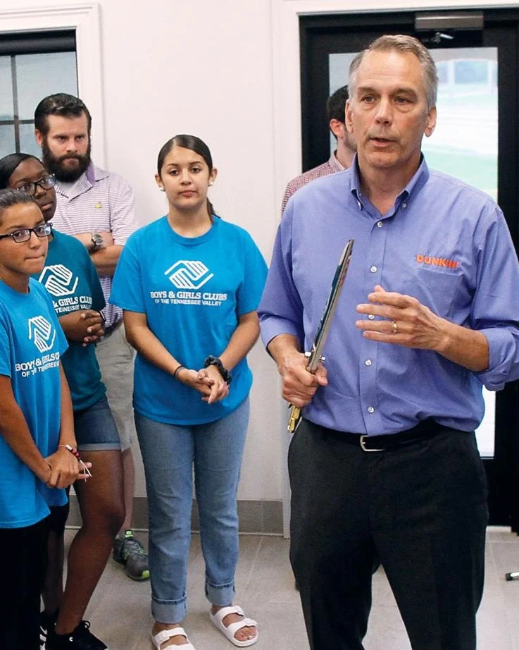 President Dave Baumgartner presenting the Boys and Girls Club a check at the Maryville New Store Opening event.