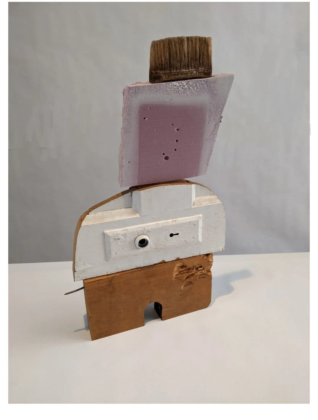   Bush-Cut , 18” × 8” × 2”, paint brush parts, scrap foamular insulation, door lock and scrap wood, 2025 