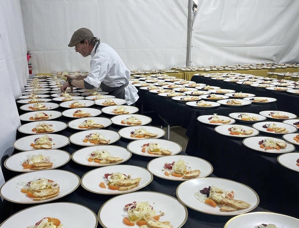 chef charles with hundreds of plates.jpg