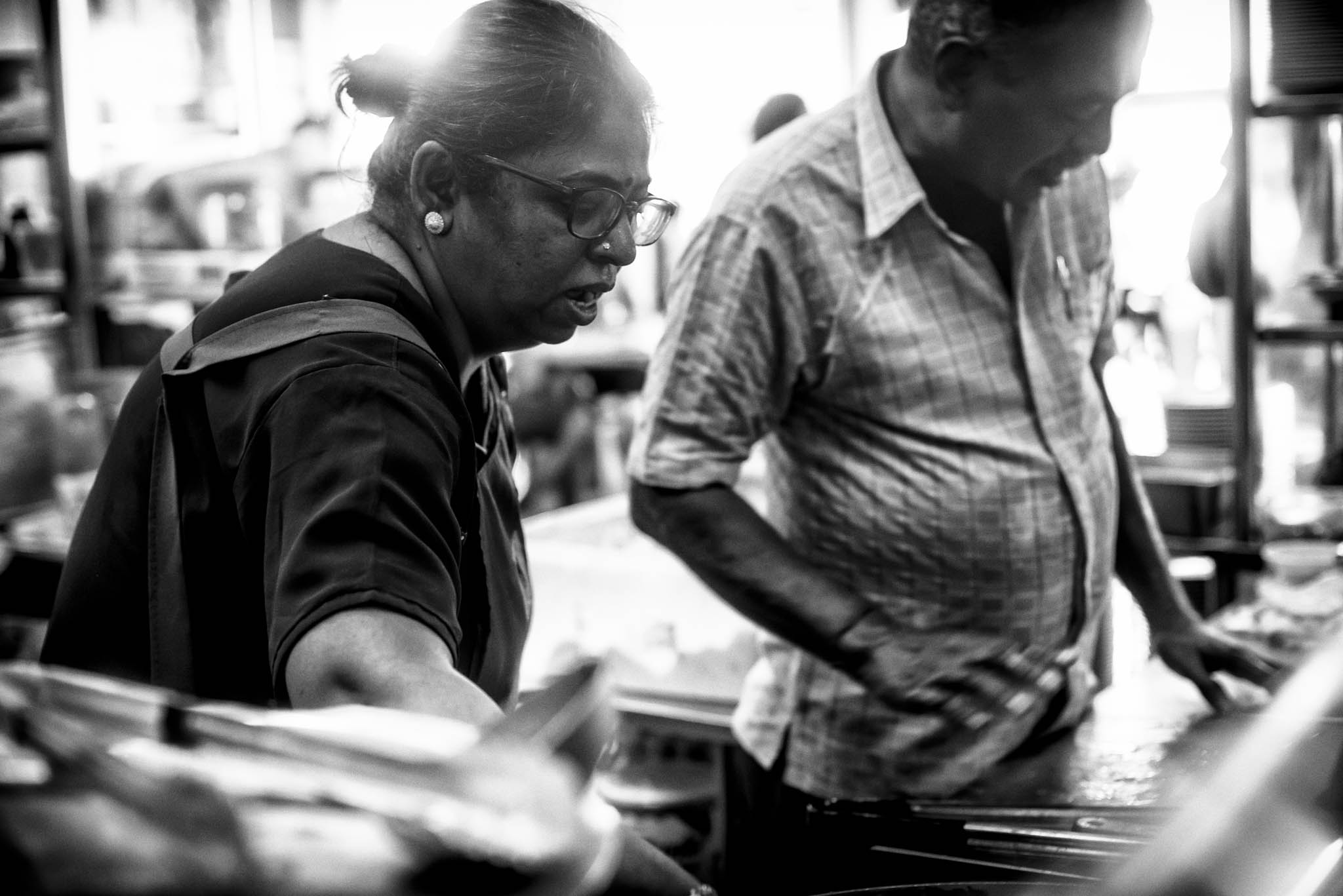 Mr and Mrs Mohgan move around the tiny stall in perfect synchrony to meet the demands of their long queues of customers daily.