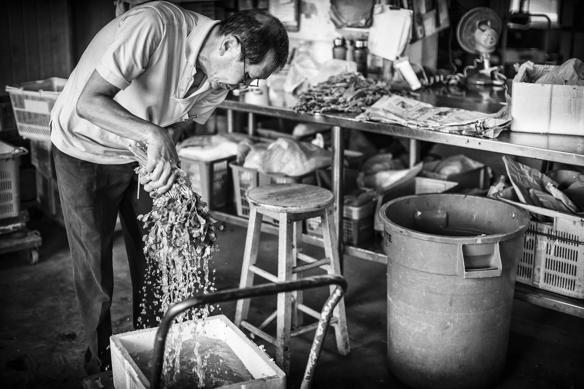 Mr Oh Yock Lee, 64, rinses vegetables before repacking them for retail sales.