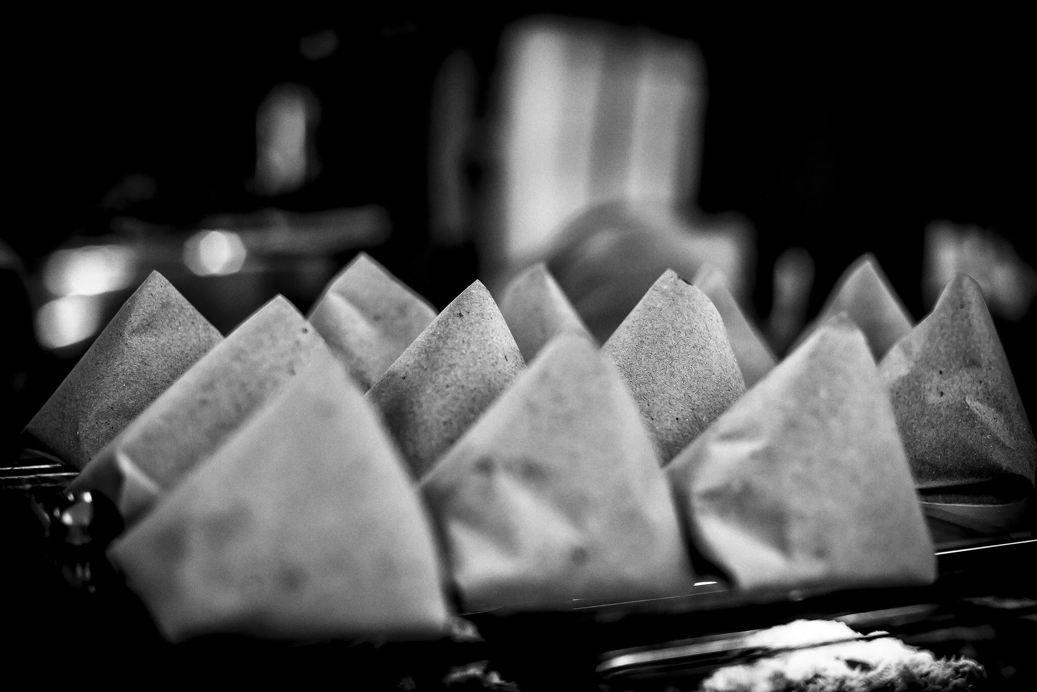 Nasi lemak is often packed into pyramidal paper packets for take-away orders.