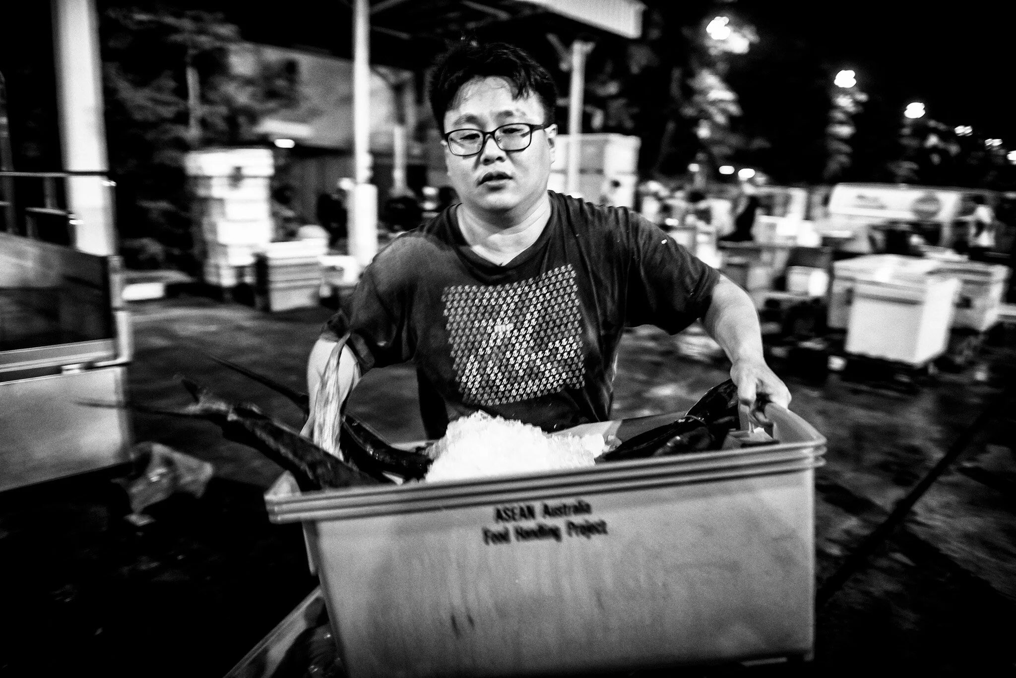 Amy Koh is reflected in the glass door of the copper still nicknamed “Nala”.