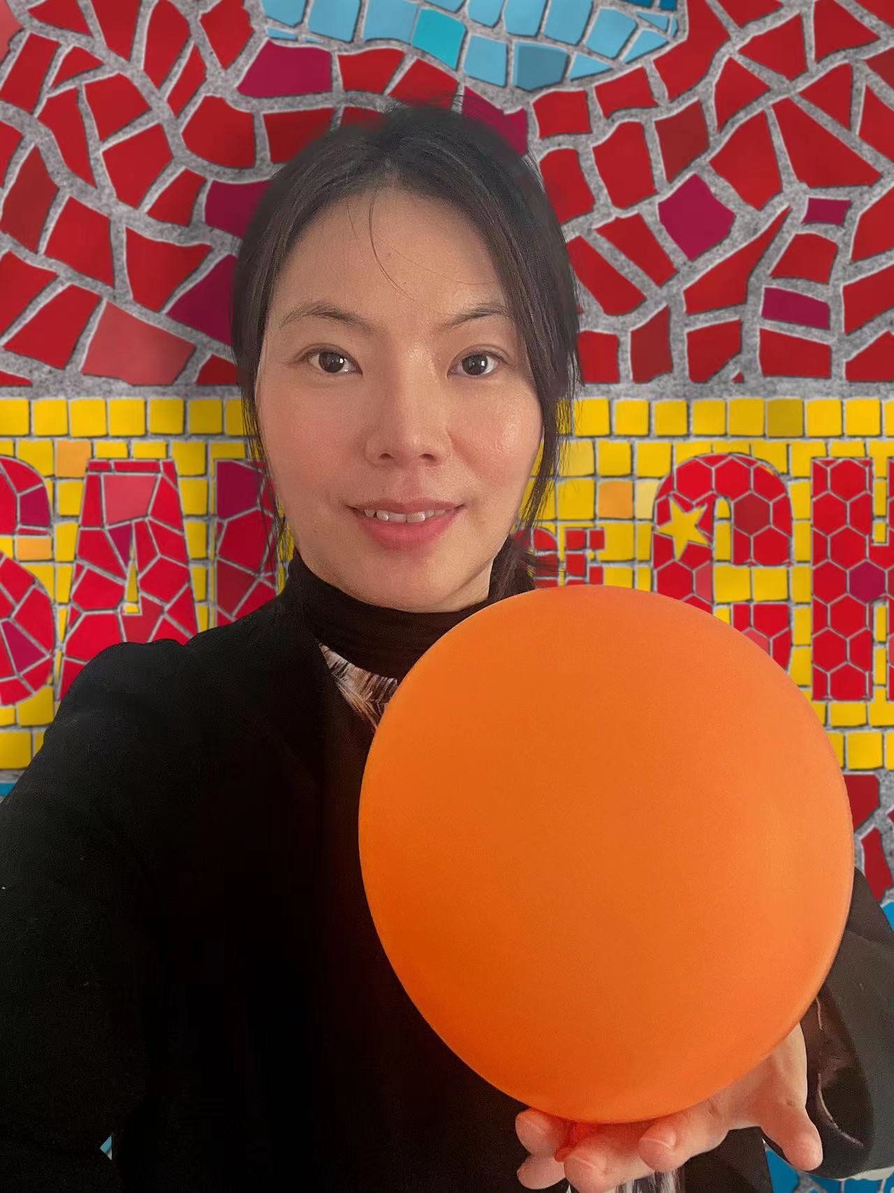 Elaine Huang's object: An orange balloon.
