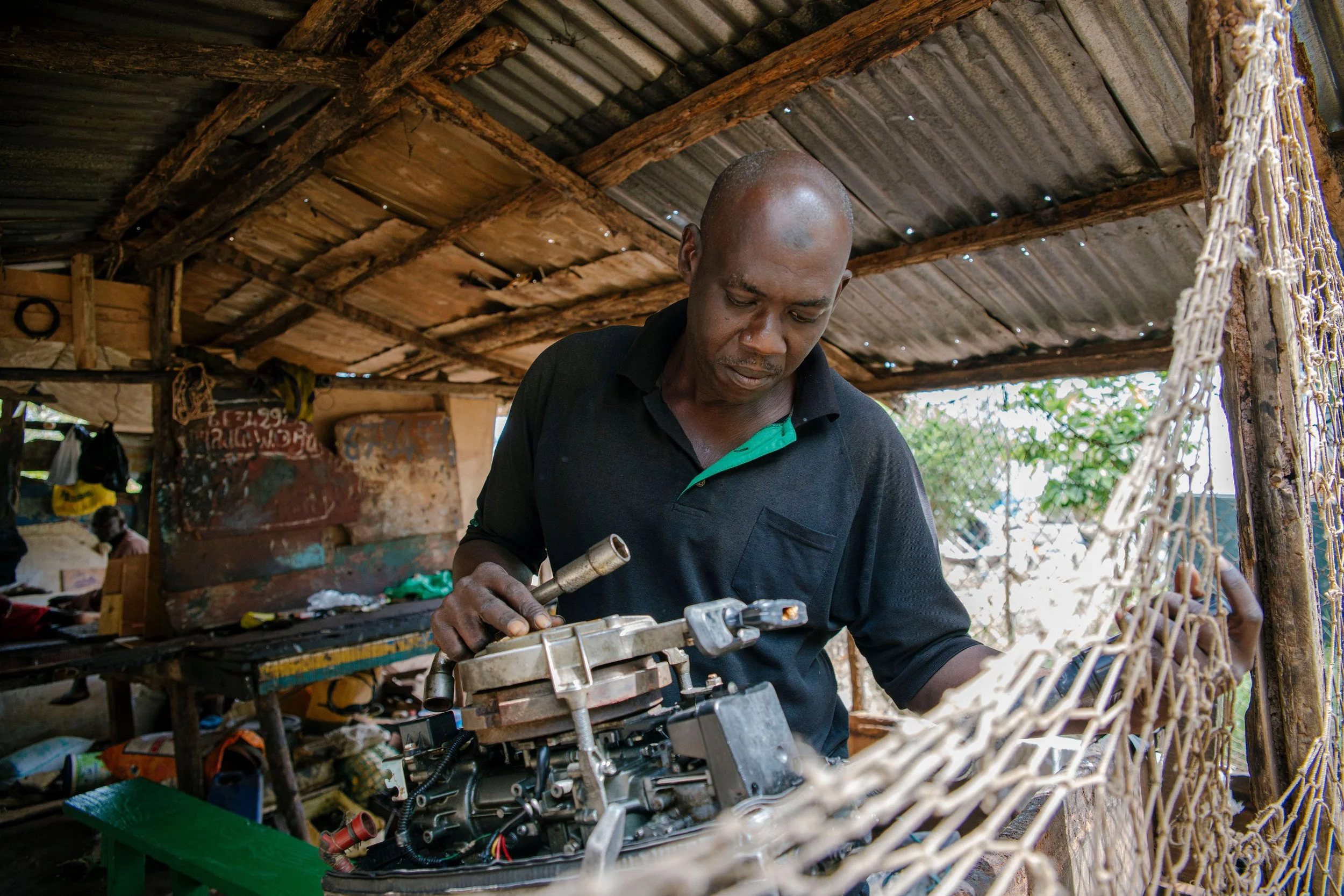 While some pirogues are operated by sail, most use engines of less than 60 HP. Boubacar Diouf, in Bissau, repairs pirogue engines.