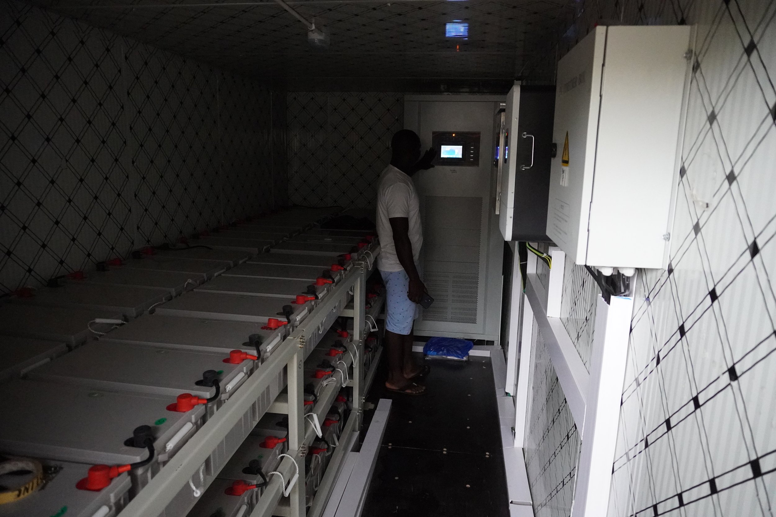  Abel Youkou has been trained to look after the machines in the solar complex. Inside the machine room there are about 100 batteries. The complex is secured by a fence and a guard keeps records of the use of the facilities. 