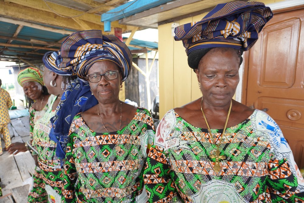  Dressed in their World Fisheries Day 2023 wax and traditional scarf, Suzanne Monye and Elizabeth Anassoukilo, two members of the COMATRANC Cooperative of Women Fishmongers and Shrimp Processors, welcome us on the site where they smoke shrimps. 