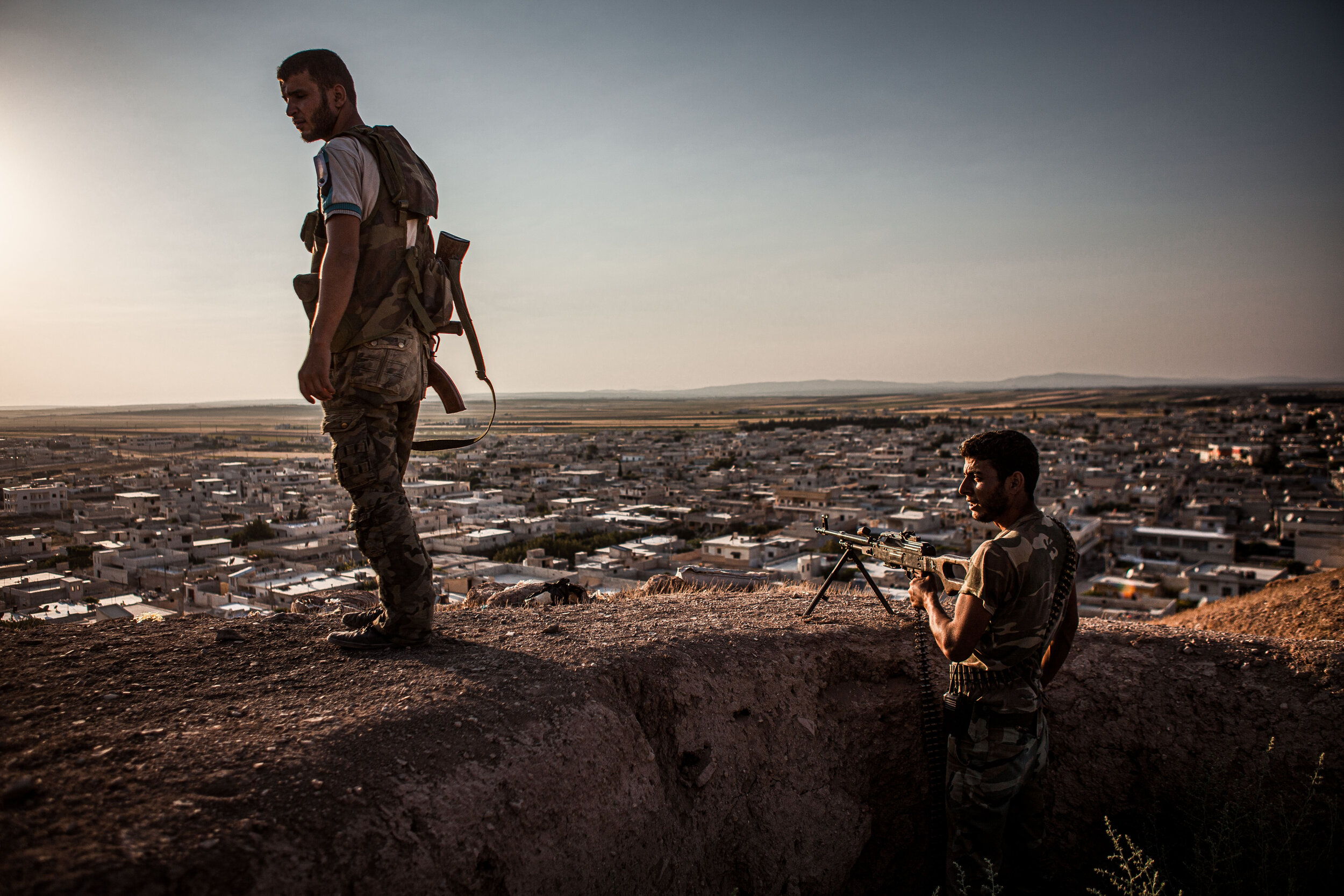  8/14/2012 Tal Rifaat, Syria: Free Syrian Army fighters from the Lions of Tawhid including Jamal Abu Houran, a defected Staff Sergeant from Deraa, right, stood watch in their fighting holes on top of the small hill that Tal Rifaat is built around.  ©